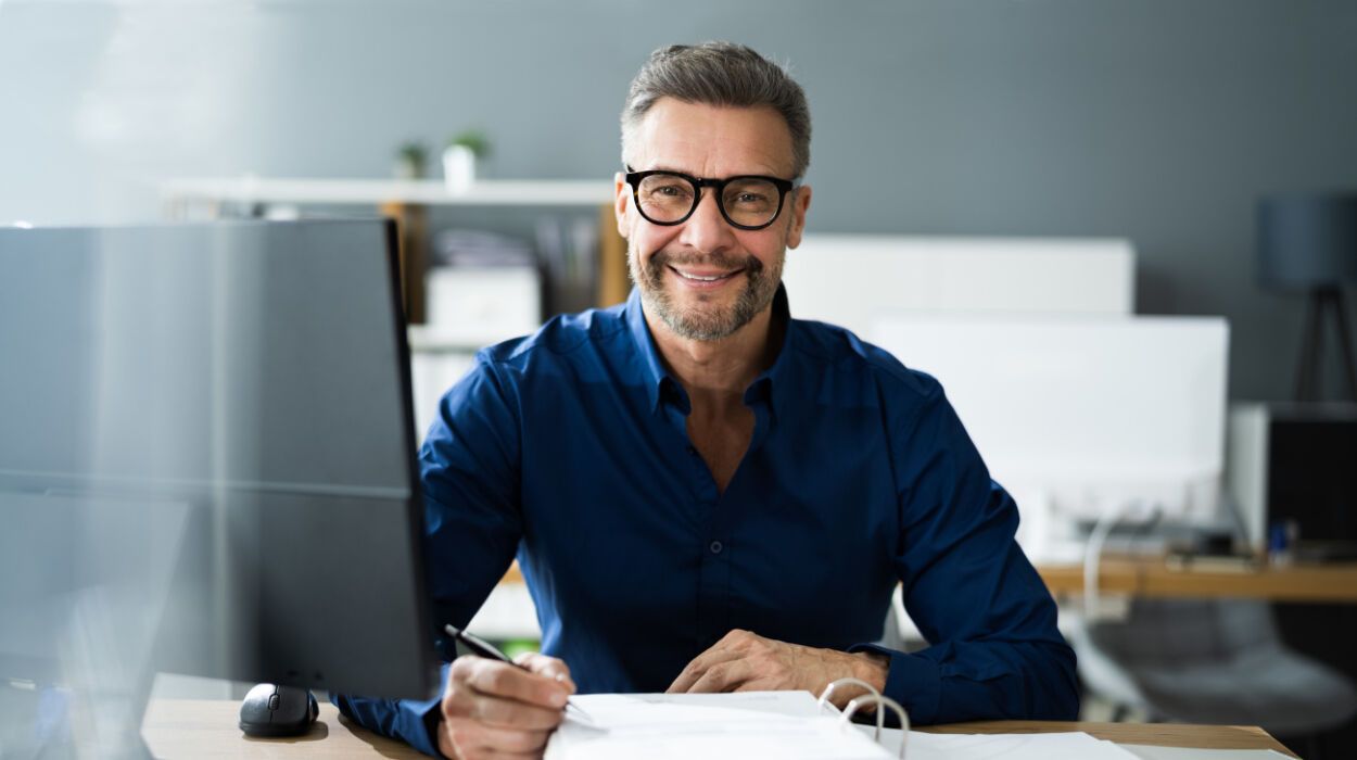 Smiling Man on His Desk